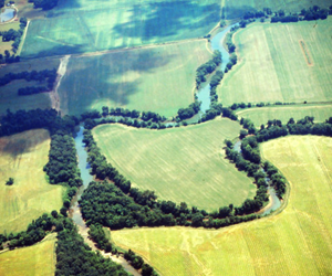 A winding river through agricultural fields